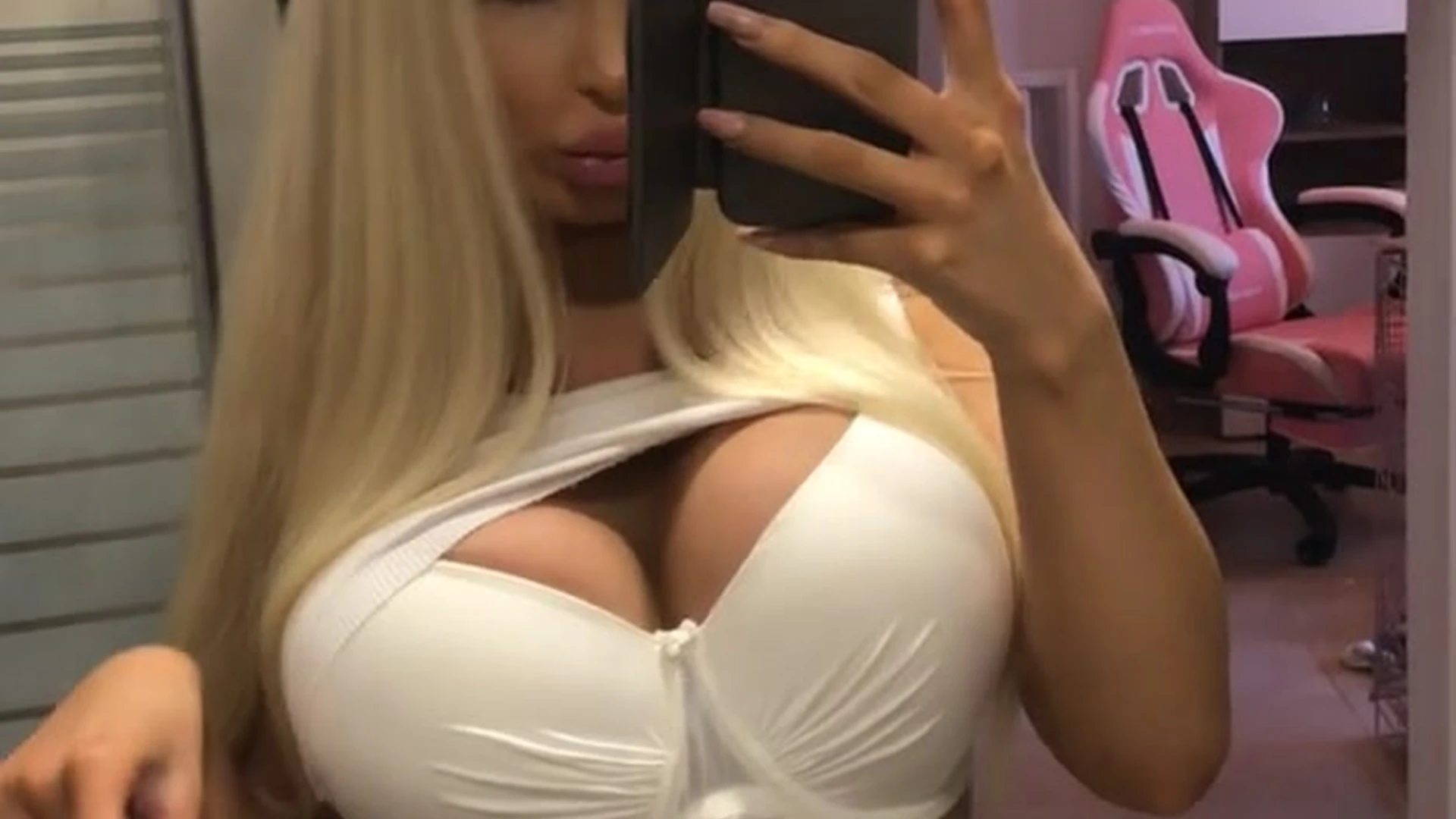 freaky slut Amanda Toy takes shots of her big tits in front of the mirror